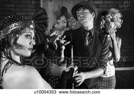 Stock Image - Prime adult Caucasian retro female taking money from Caucasian prime adult retro male in pool hall.. Fotosearch