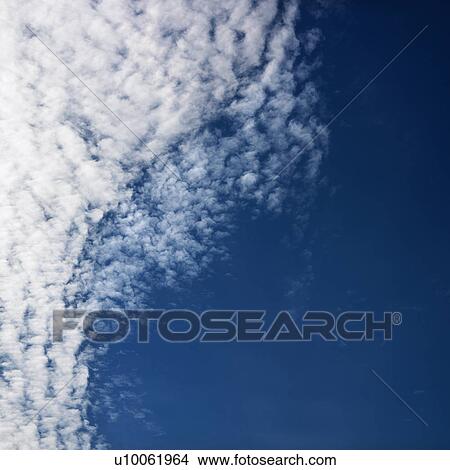 Cloud formations against clear blue sky. View Large Photo Image Picture - Cloud formations against clear blue sky.. Fotosearch