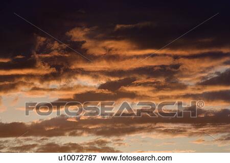 Clouds lit red at sunset in Maui, Hawaii, USA. View Large Photo Image Stock Photo - Clouds lit red at sunset in Maui, Hawaii, USA.. Fotosearch