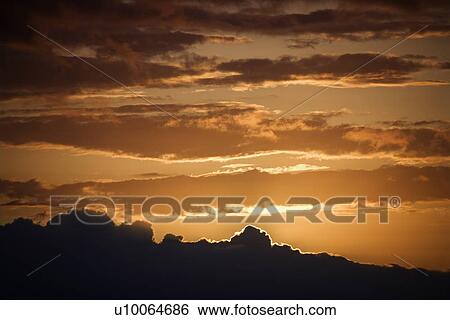 Golden sunset with glowing cloud edges in Maui, Hawaii, USA. View Large Photo Image Stock Photograph - Golden sunset with glowing cloud edges in Maui, Hawaii, USA.. Fotosearch