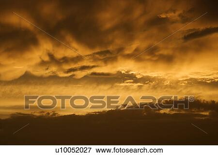Golden yellow and orange sunset sky and clouds. View Large Photo Image Stock Photo - Golden yellow and orange sunset sky and clouds.. Fotosearch
