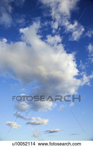 Puffy white clouds in blue sky. View Large Photo Image Picture - Puffy white clouds in blue sky.. Fotosearch