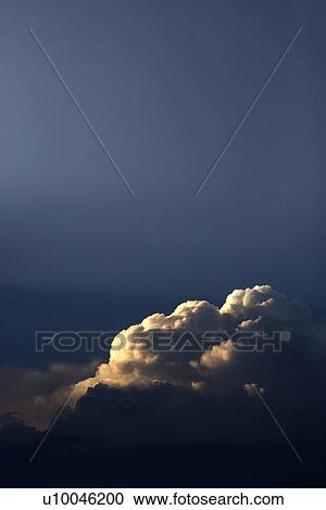 Stock Image - Sun peeking through clouds.. Fotosearch