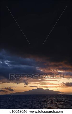 Stock Photograph - Sunset behind Kihea island and Pacific Ocean in Maui, Hawaii, USA.. Fotosearch