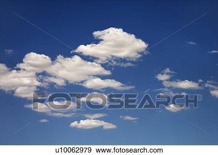 White puffy clouds in blue sky. View Large Photo Image Stock Photo - White puffy clouds in blue sky.. Fotosearch