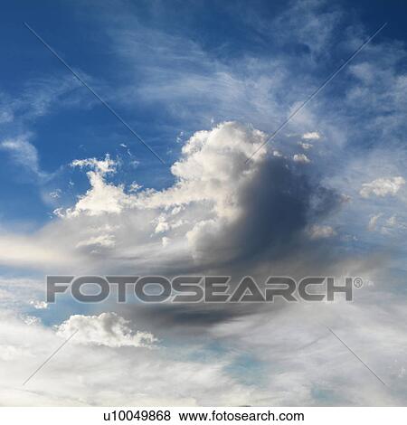 Stock Photo - Wispy cloud formations against clear blue sky.. Fotosearch