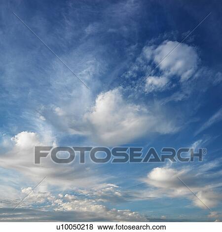 Stock Photo - Wispy cloud formations against clear blue sky.. Fotosearch