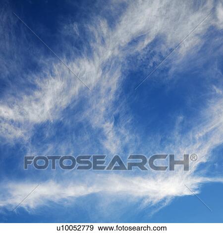 Stock Photo - Wispy cloud formations against clear blue sky.. Fotosearch