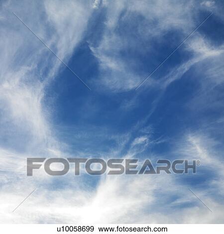 Wispy cloud formations against clear blue sky. View Large Photo Image Stock Photo - Wispy cloud formations against clear blue sky.. Fotosearch