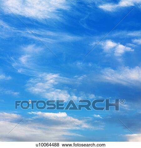 Stock Photo - Wispy cloud formations against clear blue sky.. Fotosearch