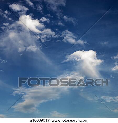 Stock Photo - Wispy cloud formations against clear blue sky.. Fotosearch