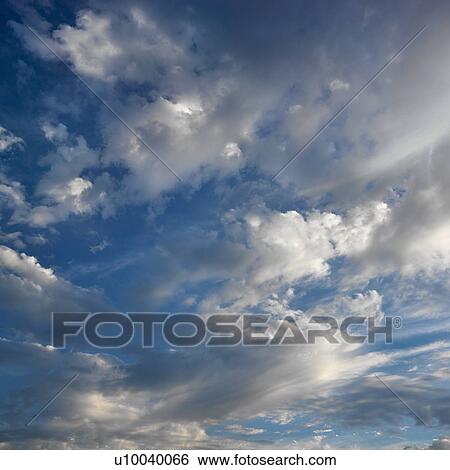 Wispy cloud formations against clear blue sky. View Large Photo Image Stock Photograph - Wispy cloud formations against clear blue sky.. Fotosearch