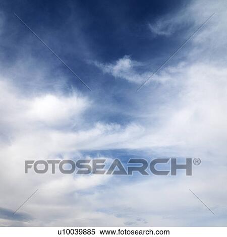 Stock Photography - Wispy cloud formations against clear blue sky.. Fotosearch