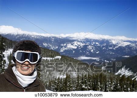 Stock Photo - Caucasian middle-aged woman skier posing on mountain.. Fotosearch