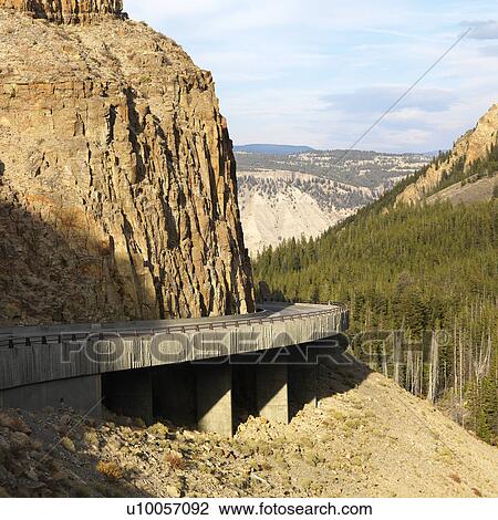 Stock Image - Highway winding through steep Wyoming mountains.. Fotosearch