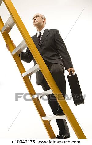 Stock Photography - Caucasian middle-aged businessman climbing ladder carrying briefcase.. Fotosearch