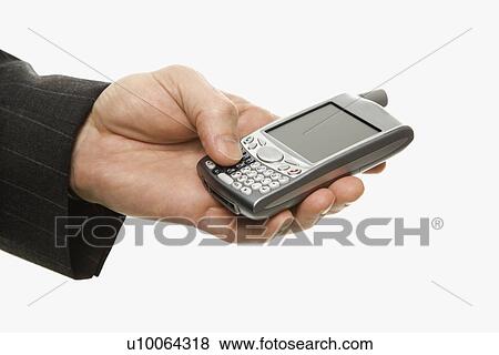 Stock Photo - Close-up of Caucasian middle-aged businessman using handheld PDA.. Fotosearch
