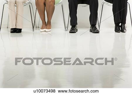 Stock Photo - Legs of multi-ethnic business group of men and women sitting.. Fotosearch