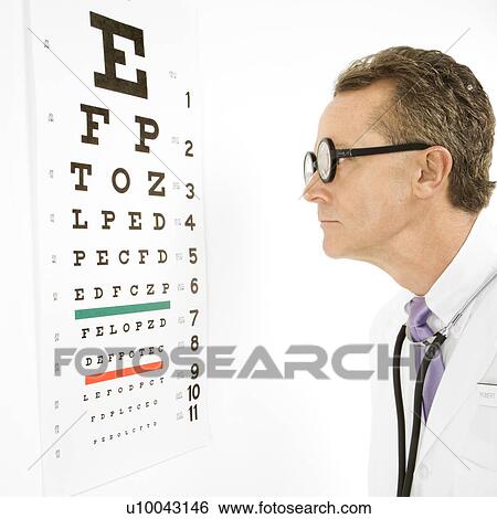 Mid-adult Caucasian male doctor wearing eyeglasses looking at an eye chart. View Large Photo Image Stock Photograph - Mid-adult Caucasian male doctor wearing eyeglasses looking at an eye chart.. Fotosearch