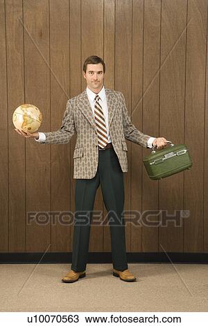Mid-adult Caucasian male in retro suit holding luggage and a globe. View Large Photo Image Stock Image - Mid-adult Caucasian male in retro suit holding luggage and a globe.. Fotosearch