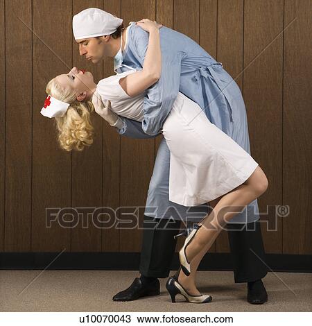 Mid-adult Caucasian male surgeon bending female nurse over backwards for passionate embrace. View Large Photo Image Stock Image - Mid-adult Caucasian male surgeon bending female nurse over backwards for passionate embrace.. Fotosearch