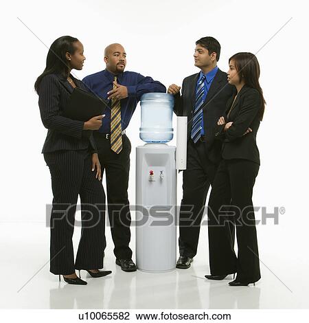 Stock Image - Multi-ethnic business group of men and women standing at water cooler conversing.. Fotosearch