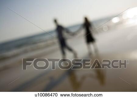 Stock Image - Couple on beach . Fotosearch