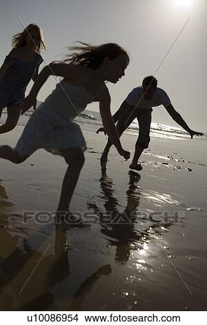 Family on beach playing together View Large Photo Image Picture - Family on beach playing together. Fotosearch