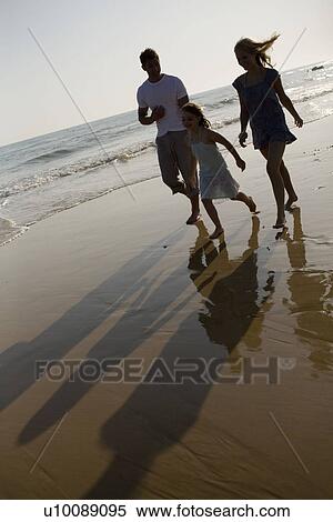 Family on beach walking together View Large Photo Image Stock Photography - Family on beach walking together. Fotosearch