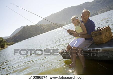 Grandfather and granddaughter fishing View Large Photo Image Picture - Grandfather and granddaughter fishing. Fotosearch