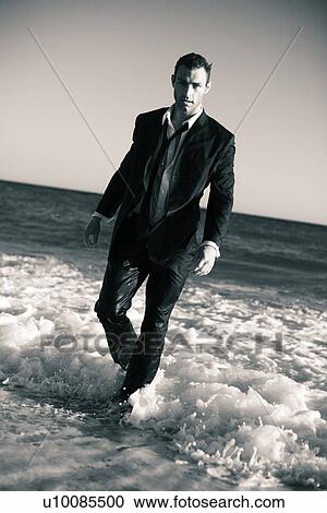 Stock Image - Man on beach. Fotosearch