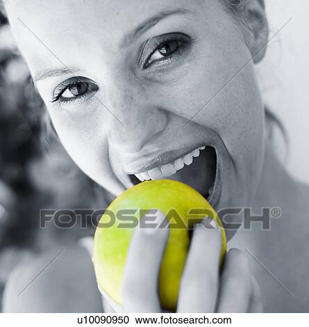 Stock Image - Woman eating apple. Fotosearch
