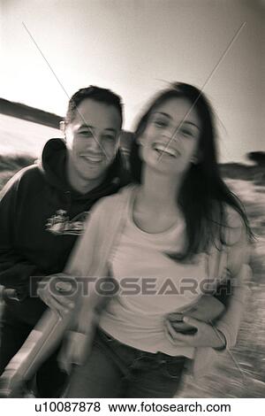 Stock Photo - Young couple running in park. Fotosearch