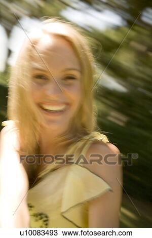 Stock Image - Young woman in motion blur. Fotosearch