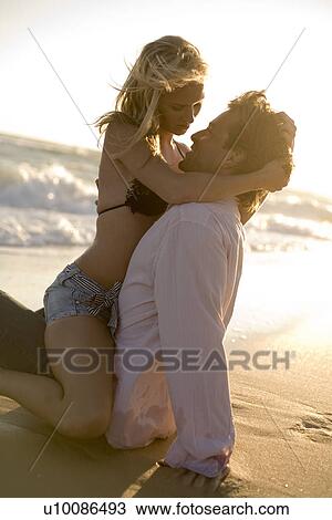 Stock Image - Couple on beach. Fotosearch