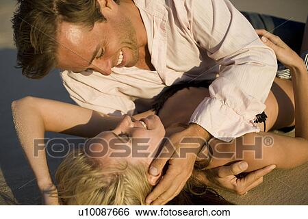Stock Photograph - Couple on beach. Fotosearch