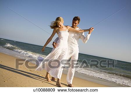 Couple walking on beach View Large Photo Image Stock Photo - Couple walking on beach. Fotosearch