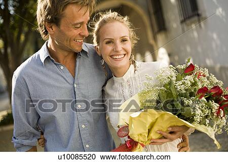 Couple with flowers View Large Photo Image Stock Image - Couple with flowers. Fotosearch