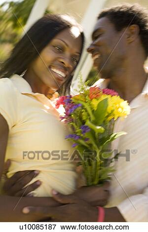 Stock Photo - Couple with flowers. Fotosearch