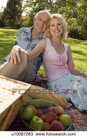 Stock Image - Mature couple in park. Fotosearch
