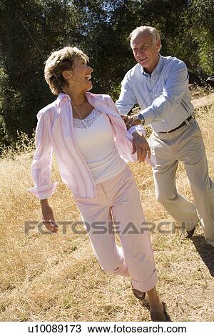 Stock Image - Mature couple in park. Fotosearch