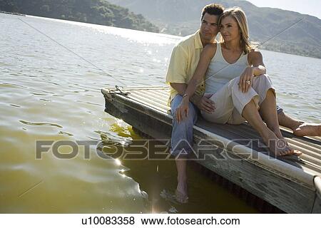 Stock Photo - Young couple by lake. Fotosearch