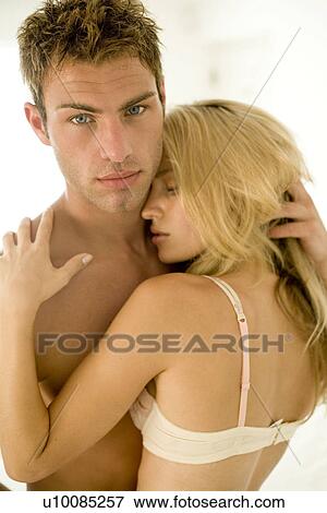Stock Photo - Young couple in bedroom. Fotosearch