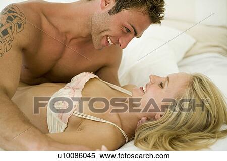 Young couple in bedroom View Large Photo Image Stock Photography - Young couple in bedroom. Fotosearch