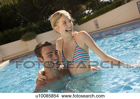 Young couple in pool View Large Photo Image Picture - Young couple in pool. Fotosearch