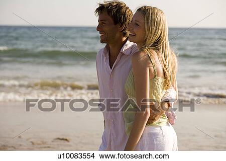 Young couple on beach View Large Photo Image Picture - Young couple on beach. Fotosearch