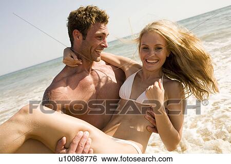 Young couple on beach View Large Photo Image Stock Photograph - Young couple on beach. Fotosearch