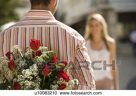 Couple, man with flowers View Large Photo Image Stock Image - Couple, man with flowers. Fotosearch