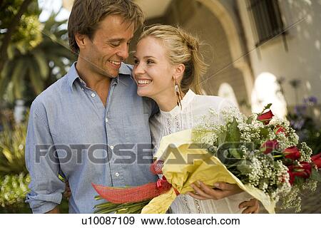 Couple with flowers View Large Photo Image Stock Photo - Couple with flowers. Fotosearch