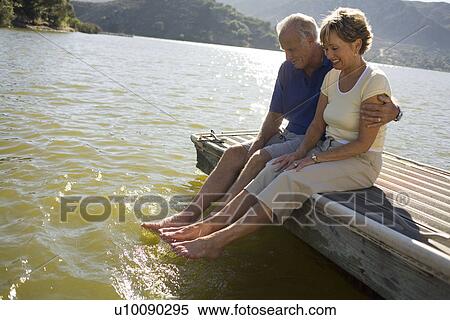 Stock Photography - Mature couple by lake. Fotosearch